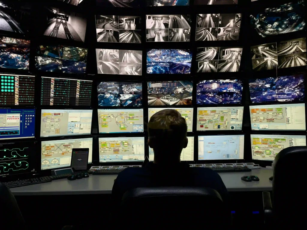 A security operator monitoring multiple surveillance feeds in a control room