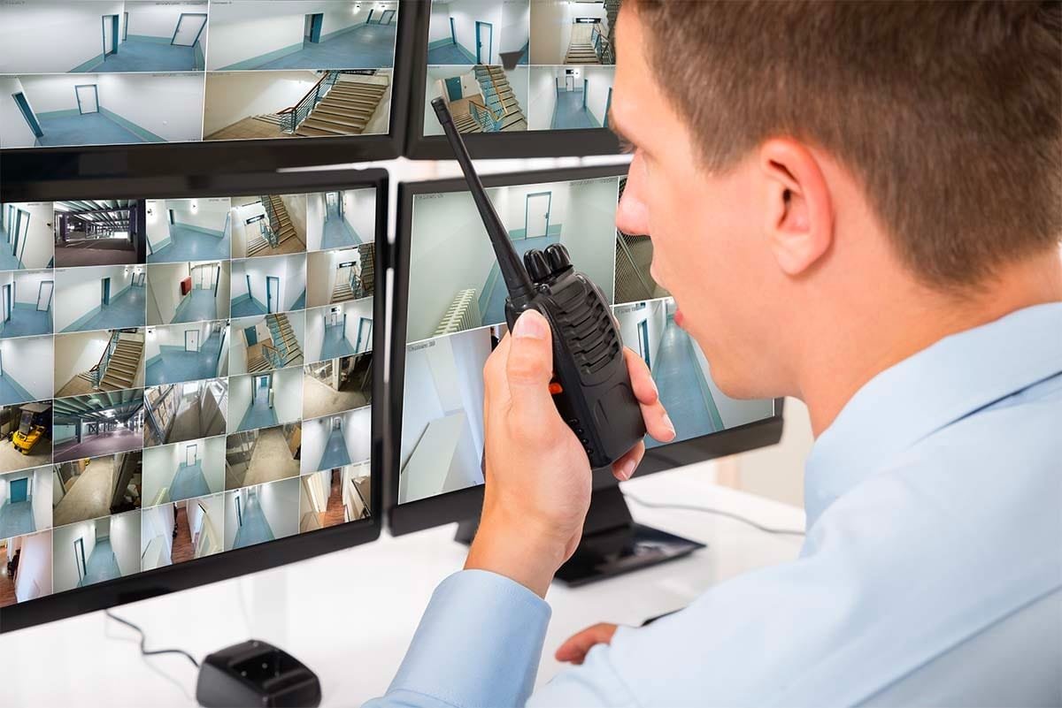 A professional operator in a call center setting, wearing a headset, symbolizing virtual doorman services and remote monitoring solutions.
