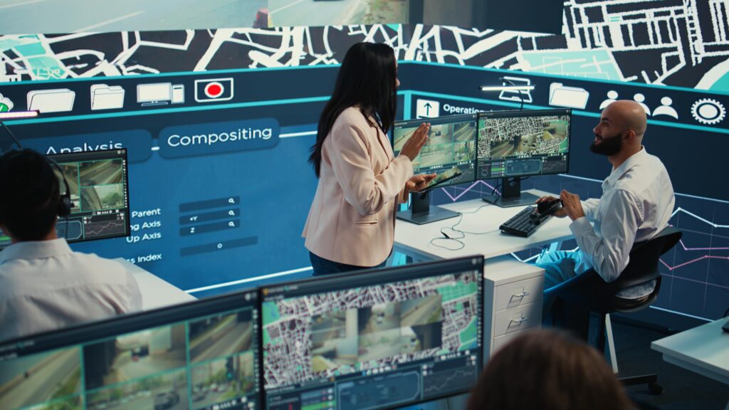A professional CCTV Monitoring command center, showing multiple screens displaying various camera feeds and operators working. This highlights extensive security cameras infrastructure and professional CCTV Monitoring Services for enhanced business CCTV.
