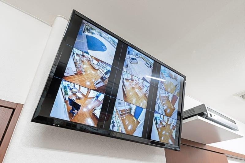 Wall-mounted TV displaying multiple live feeds for efficient CCTV monitoring.