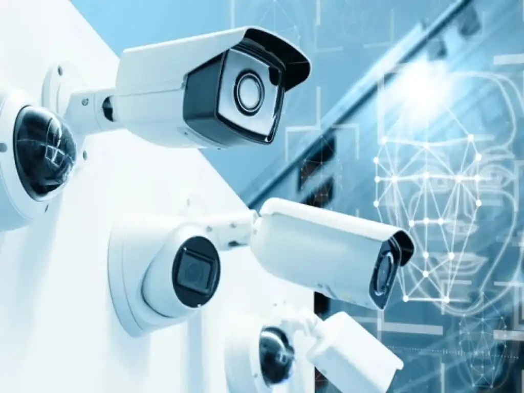 Multiple security cameras mounted on a wall, connected to a digital network, representing modern CCTV Monitoring and Remote CCTV Services.