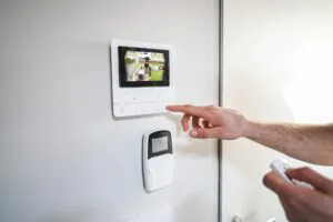 A collage of security concepts, including a person using an intercom, a keycard access control panel, and an operator performing virtual doorman services for GCCTVMS.