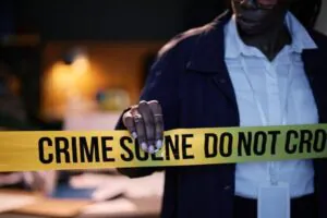 Man in a jacket sitting in a dark control room in front of a monitor, focused on CCTV Monitoring.