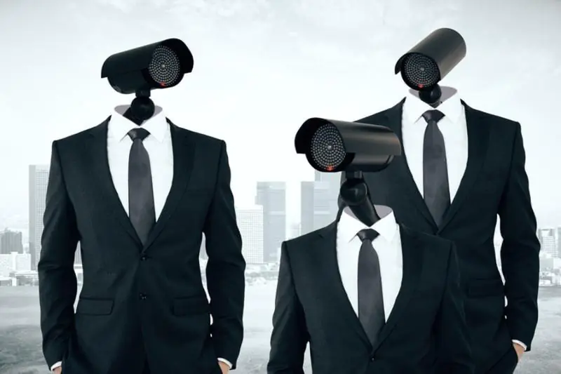 A surreal conceptual image featuring three men in suits with security cameras for heads, symbolizing the omnipresent nature of remote CCTV monitoring
