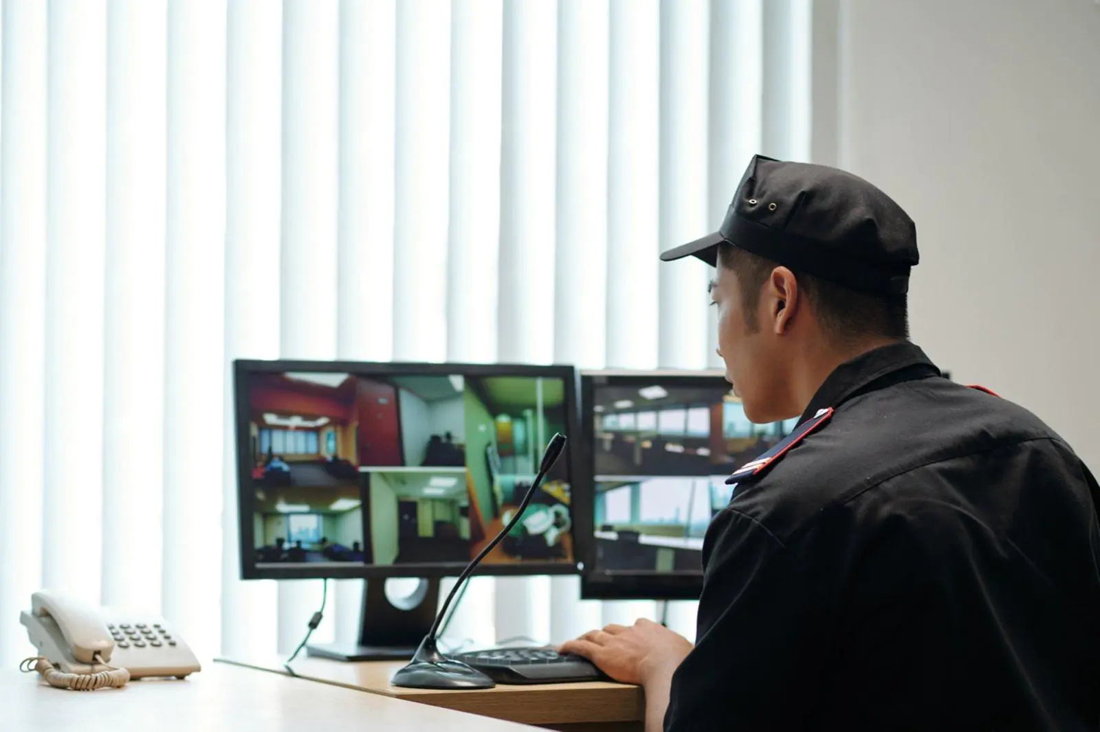 A professional operator in a uniform monitoring screens and using a microphone, representing the efficiency of Virtual Receptionist Services and Professional Answering for Small Business Solutions